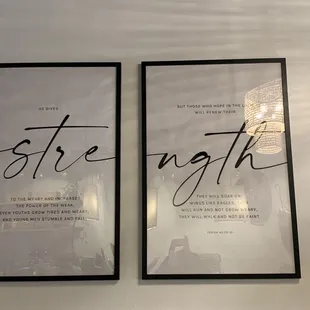 two framed posters on a wall