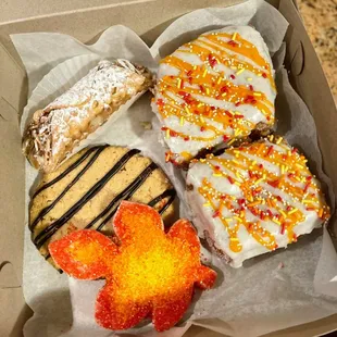 Cannoli, kronuts, peanut butter cookie with drizzle chocolate, &amp; sugar cookie.
