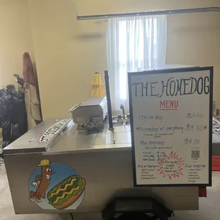 a hot dog cart with a menu on it