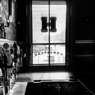 a black and white photo of a bar