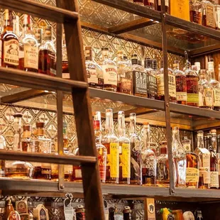 a shelf full of liquor bottles