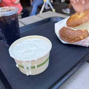 a tray with a sandwich and a drink