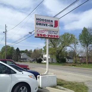 a car parked next to a sign