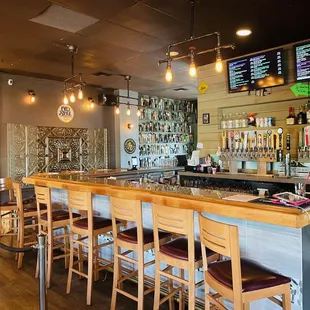 a bar with a row of bar stools