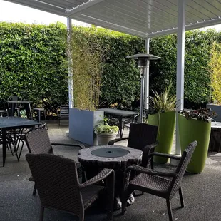 a patio with tables and chairs