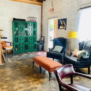 a living room with chairs and a table