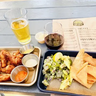 a tray of food and a glass of beer