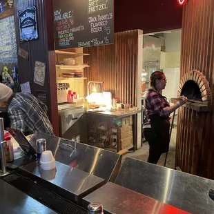 Pizza oven and staff at Hopper&apos;s