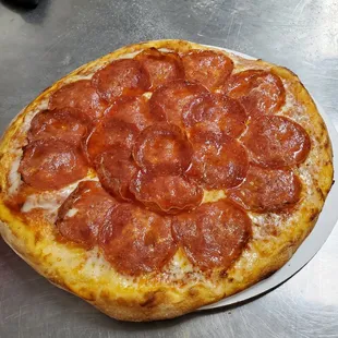 Artisan hand thrown pepperoni pizza. We slice blocked cheese and stick pepperoni to ensure we get the best quality ingredients we can source