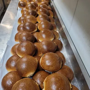 We egg wash each bun, then bake them in our ovens until they are golden brown on the outside and light, fluffy, and buttery, on the inside.