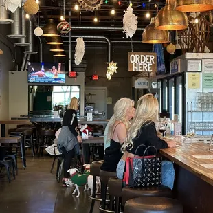 two women sitting at a bar