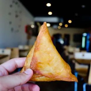 a hand holding a piece of food