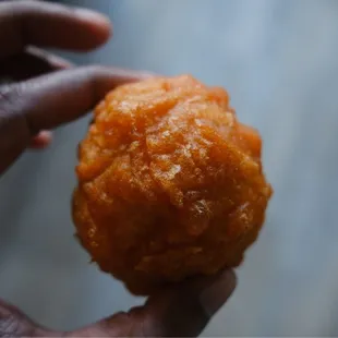 a person holding a piece of food