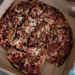 The 5 meat with &quot;pineapple&quot; pizza my husband ordered (he can barely chew the crust it is so crunchy burnt)