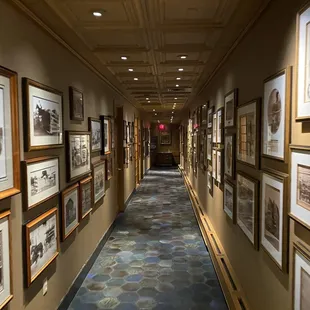 a long hallway lined with framed photographs