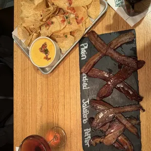 Queso and chips and flight of bacon
