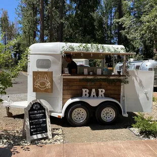 Elevate your event with The Horseshoe Bar charming mobile bar horse trailer!  Serving up craft cocktails with a side of rustic elegance.