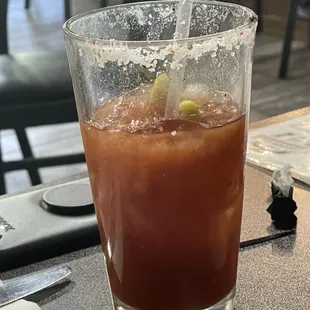 Bloody Mary came with spear holding pickle, pickled okra, olive &amp; lime.