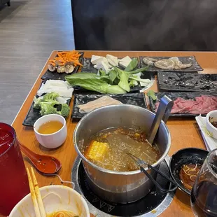 a pot of soup with chopsticks on the table