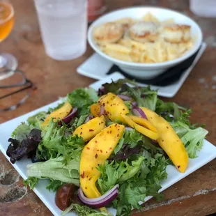 a plate of salad and a glass of wine