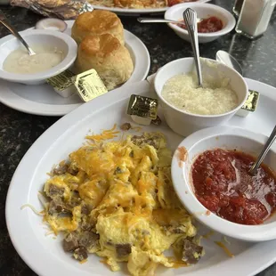 Scrabbled eggs with sausage, grits and buiscuits and gravy
