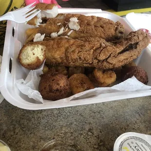 a basket of fried fish and potatoes