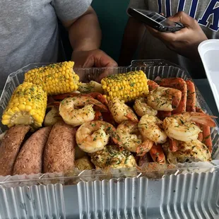 a tray of shrimp and corn