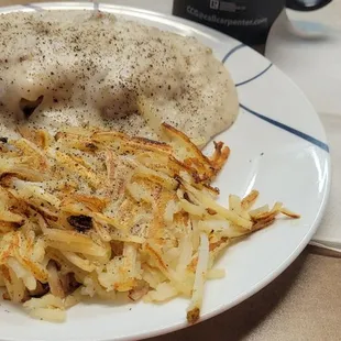 Half order of Biscuits and Gravy with a side of hash browns.