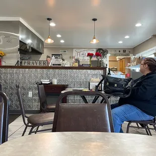 a woman sitting at a table in a restaurant
