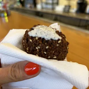 a person&apos;s hand holding a pastry