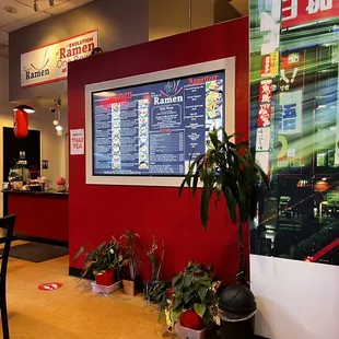 a restaurant with a menu on the wall