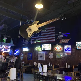 a guitar suspended from the ceiling