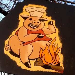 a pig roasting a fire