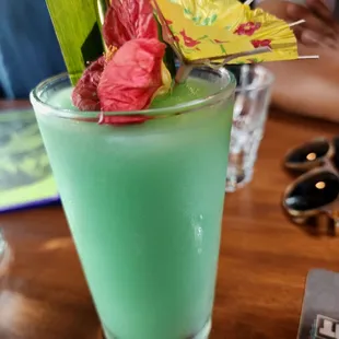 a green drink with flowers in it