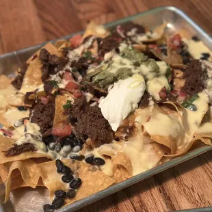 Flockin' Taco Night  Loaded Barbacoa Nachos $13 Barbacoa I Black Beans I Nacho Cheese Sour Cream I Guacamole I Pico de Gallo I Cilantro
