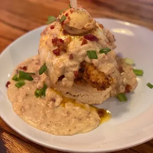 "HOUSE CHICKEN 'N BISCUIT 'N GRAVY STACK" Crispy Chicken Tenders, Over Medium Egg, Bacon White Gravy, served on a  Giant Butter Biscuit.