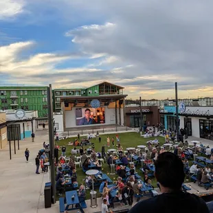 a crowd of people sitting in lawn chairs