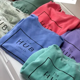 a variety of t - shirts on a counter