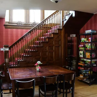 a dining room with a wooden table and chairs