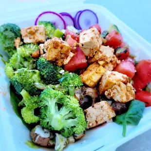 a salad in a styrofoam container