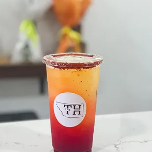 a drink in a plastic cup on a table