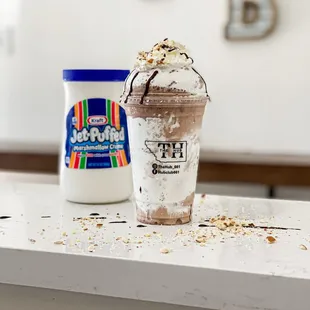 a cup of ice cream and a bottle of milk