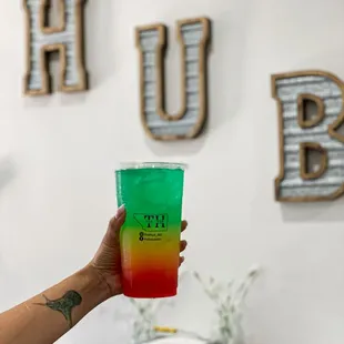 a person holding a cup of juice