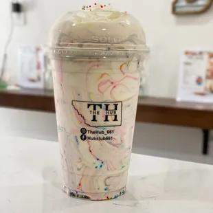 a cup of ice cream with sprinkles