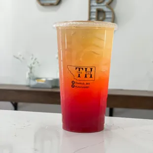 a drink in a plastic cup on a counter