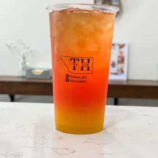 a drink in a plastic cup on a counter