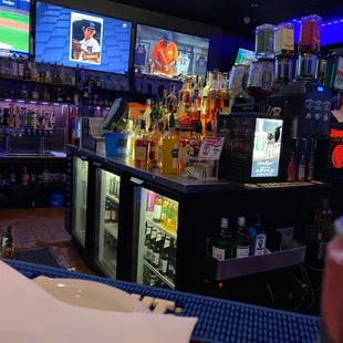 a bar with several televisions