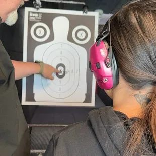 Paul is pointing out the bull's-eye on the first ever fired shot. :)