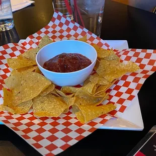 a bowl of salsa and chips