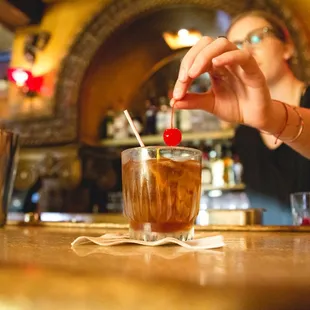 a woman pouring a drink